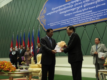 Samdech Akeak Moha Sena Padey Decho Hun Sen handing over the CRPD and Incheon Strategy in Khmer language to H.E. Dr. Ith Sam Heng, Minister of Social Affairs, Veterans and Youth Rehabilitation and the President of Disability Action Council   