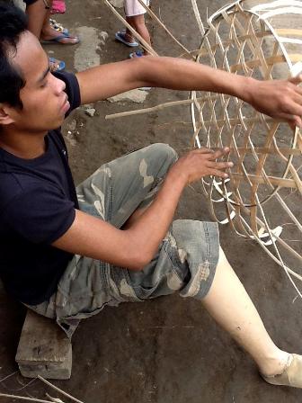 Person with Disabilities Weaving a Coconut Palm Basket for Vegetables