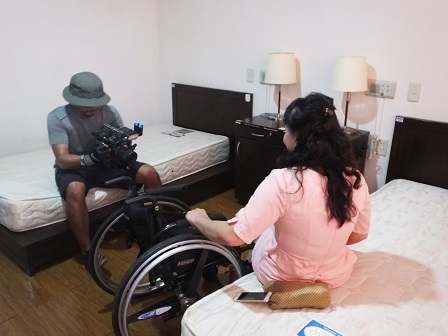 Ms. Nongnuch demonstrates how a wheelchair user has easy access to APCD Training Building's accommodations