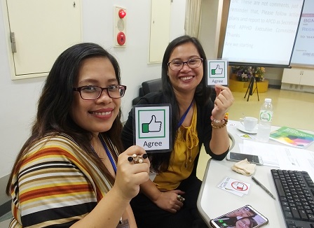 Participants from the Philippines holding up accessible communication cards
