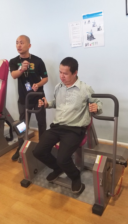 Mr. Watcharapol trying out the facilities at Enabling Village's Inclusive Gym