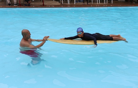Learning to use the surfboard at the pool