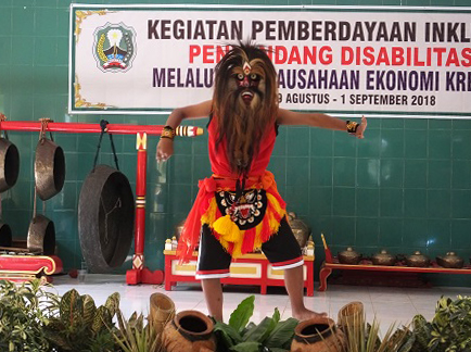 Colorful traditional dance by person with intellectual disability