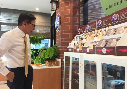 Mr. Wiboon looks at the variety of 60+ Plus Chocolate by MarkRin products on display