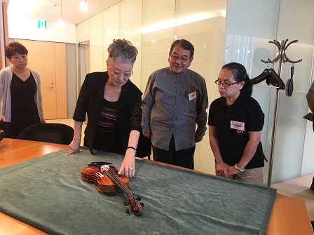 Mdme. Kazuko Shiomi (Nippon Music Foundation Chairperson) showing APCD one of the Stradivarius violins in the Foundation's collection