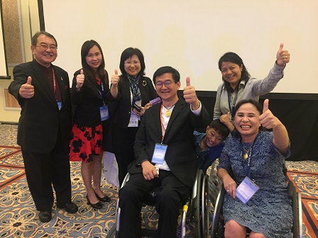 APCD Executive Board member Mr. Krisana Lalai (President, Friendly Design for All Foundation) with fellow disability advocates giving thumbs-up signs