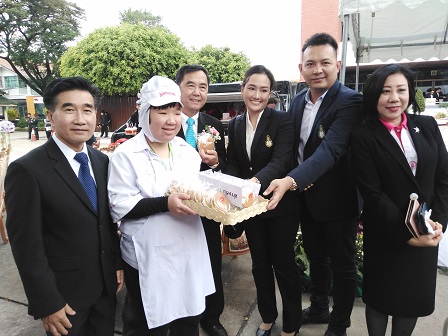 Bakery staff with disability offering products to VIP guests