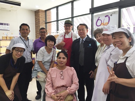Group photo with 60 Plus+ Bakery & Cafe staff with disabilities