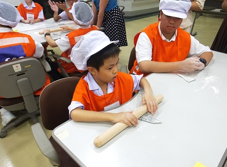 Young visitors trying their hand at kneading dough