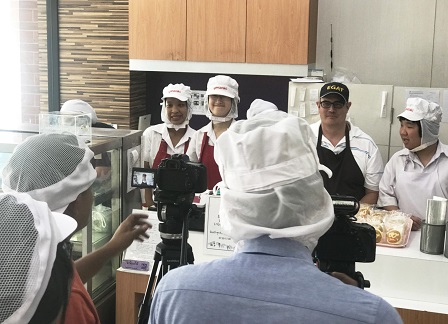 Camera crew with 60+ Plus Bakery & Cafe staff with diverse disabilities