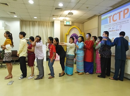 Participants in their national attire queue up for an icebreaking activity