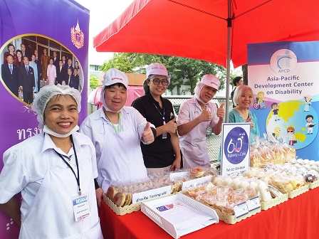 60 Plus+ Bakery & Cafe staff gives a thumbs-up sign in their designated booth
