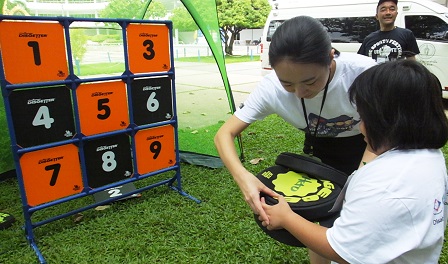 Participant with autism getting basic lessons in Dodgbee-throwing