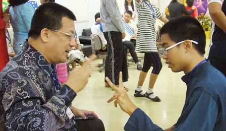Malaysian father and son playing rock, paper, and scissors