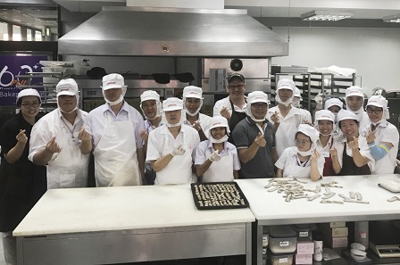 Group photo of 60+ Plus Bakery & Cafe staff with diverse disabilities