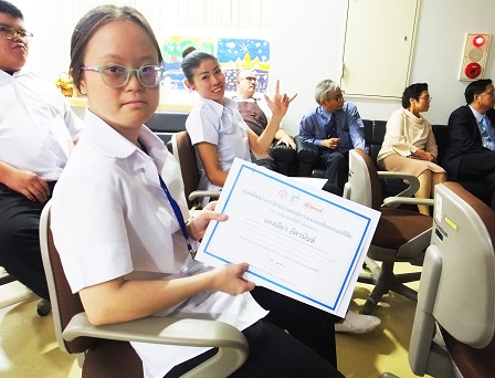 Trainee with disability proudly shows off her certificate of completion