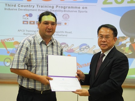 APCD Executive Director presents certificate of completion to resource persons with autism Mr. Timothy Ninomiya