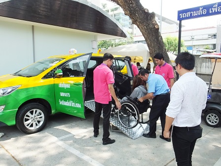 Wheelchair user trying out the accessible taxi during a demonstration