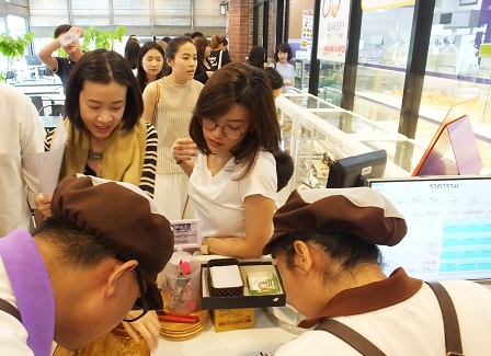 Visitors ordering coffee and chocolate drinks at the cafe