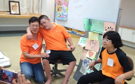 Siblings with their father at the group presentation