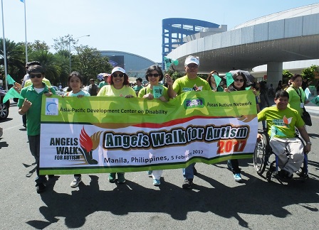 APCD's banner held aloft by partners, friends and supporters