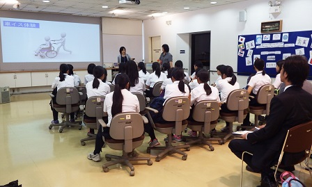 APCD staff explaining how to use wheelchair to students