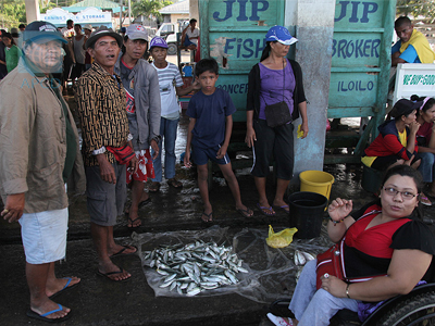 Person with Disabilities Distributing Fish to Customers